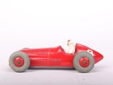 a red toy car with a man sitting in the driver ' s seat