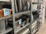 many pots and pans on the shelves in the kitchen