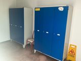 two blue and white lockers and a chair in a room