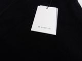 a black shirt with a white tag hanging on it