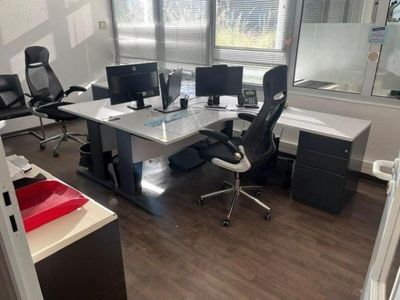 an image of an office with a desk and computer monitors