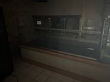 a glass display case in the middle of a kitchen