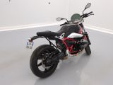 a black and red motorcycle parked in a white room
