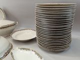 a lot of plates and bowls sitting on a table