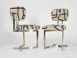 a pair of chairs with a black and white design on them