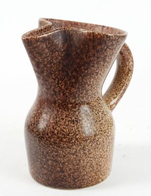 a brown vase with a handle on a white background