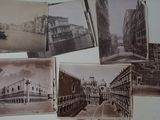 many old photos of a city on the wall