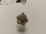 a close up of a silver ring with a flower on it