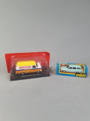 two toy cars that are next to each other on a table