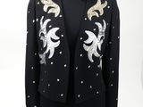 a black jacket with gold and silver sequins on it