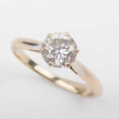a gold engagement ring with a round brilliant cut diamond