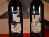 two bottles of wine that are sitting on a table
