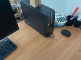 un ordinateur de bureau posé sur un pupitre en bois