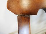 a close up of a wooden chair with a wooden seat