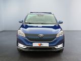 the front view of a blue suv parked in a showroom