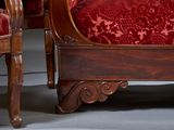 a red couch and a chair in a room