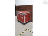 an image of a red trunk sitting on top of a cement floor