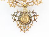 a gold necklace with a picture of a woman on it