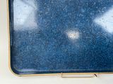 a blue suitcase sitting on a table with a white background