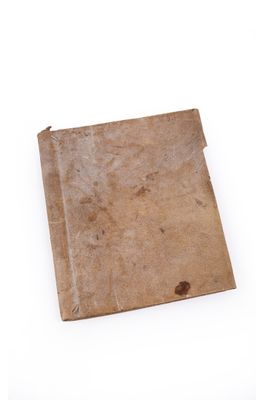 an old book on a white surface with a white background