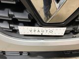 a close up of a car ' s grille with a sticker on it