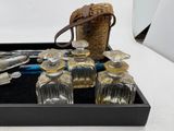 a tray that has a bunch of glass bottles and spoons on it