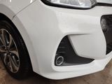 a close up of a white car in a garage