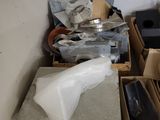 a pile of boxes and other items in the corner of a room