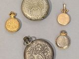 several different types of silver and gold jewelry on a white surface