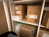 a shelf with boxes and a laptop on top of it