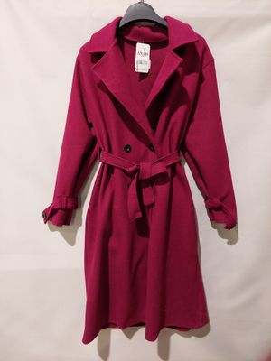a red coat with a belt is hanging on a hanger