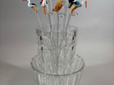 a glass vase with a bunch of birds in it