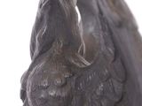 statue of a bird on a pedestal on a white background