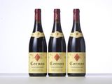 three bottles of red wine sitting on top of a table