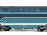 a blue train that is on the tracks on a white background