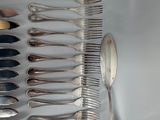 a lot of silver spoons and silverware on the table