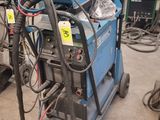 a blue machine that is sitting in a garage