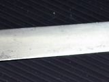 a close up of a knife on a black surface
