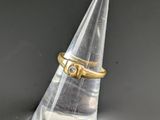 a close up of a clear cone with a gold ring on top of it