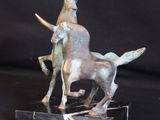 bronze sculpture of a goat and a goat on a marble base