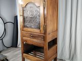 a wooden cabinet with a door on top of it