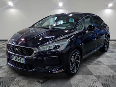 the black car is parked on a checkered floor in the garage