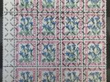 a stamp with blue flowers on it on a black surface