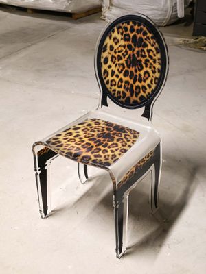 a chair that has a leopard print seat on it