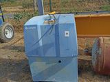 a blue machine that is sitting in the dirt