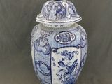 un vase bleu et blanc avec un couvercle posé sur une table