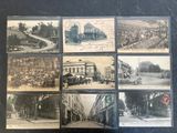 an old photo of a bunch of old postcards on a table