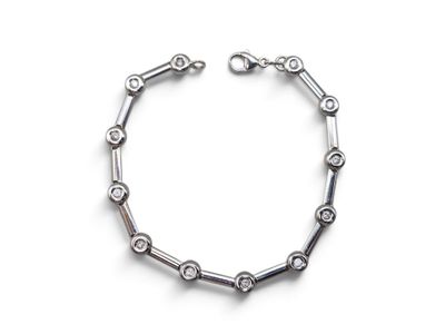 a close up of a bracelet on a white surface