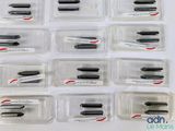 a lot of pens in plastic containers on a table