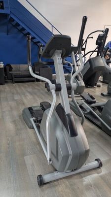 a row of stationary exercise bikes in a gym